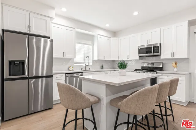 a view of a kitchen with a table and chairs