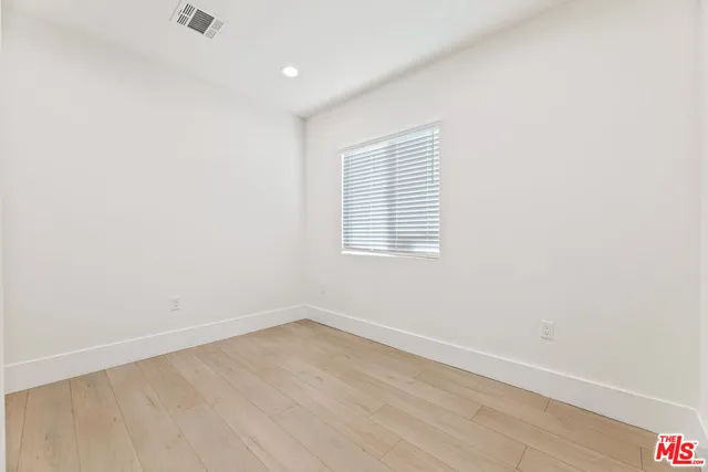 an empty room with wooden floor