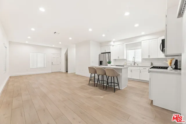 a kitchen with granite countertop a sink stove and cabinets