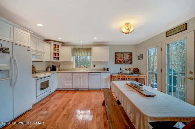 a kitchen with stainless steel appliances a stove a sink and a refrigerator