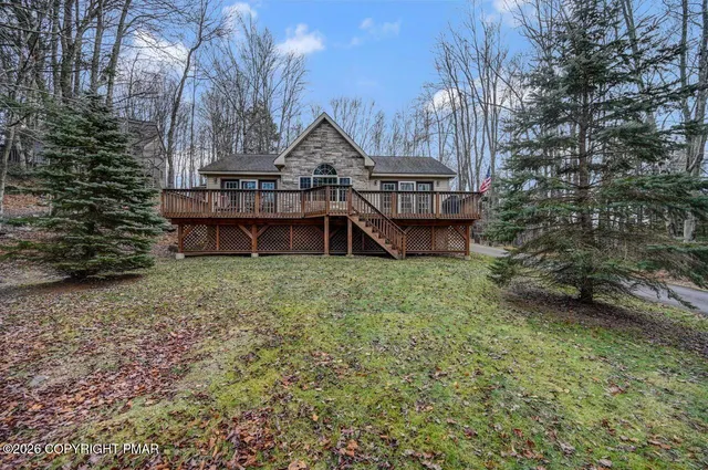 a view of a house with a yard and hanging chair