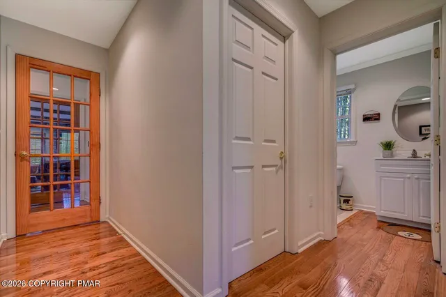 a view of a hallway and a livingroom with furniture