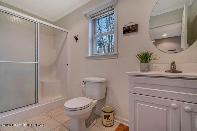 a bathroom with a toilet a sink and a mirror