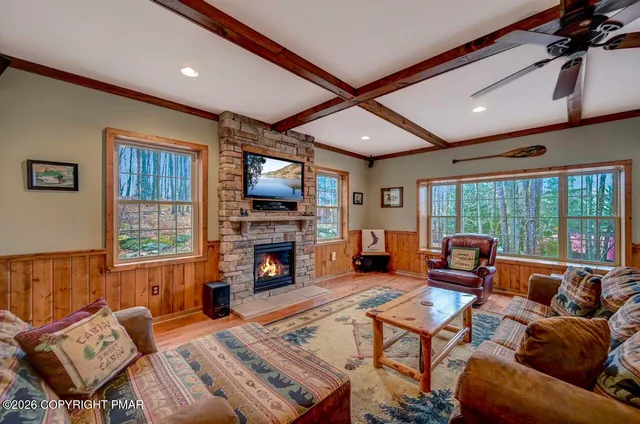 a living room with fireplace furniture and a flat screen tv