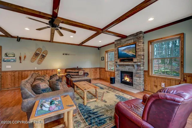 a living room with furniture a fireplace and a flat screen tv