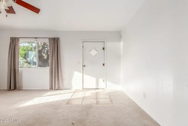 a view of an empty room with a window