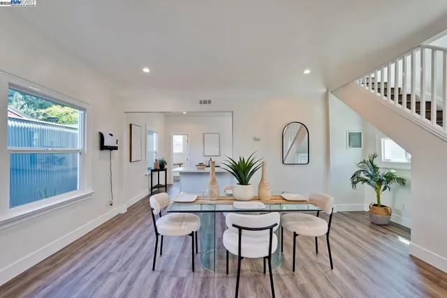 a dining room with furniture and wooden floor