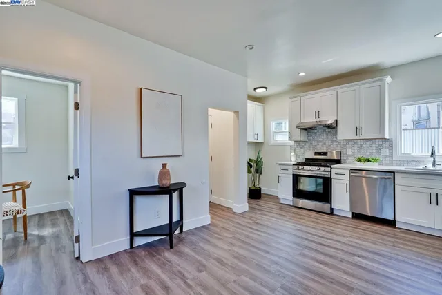 a kitchen with stainless steel appliances granite countertop a refrigerator and a stove top oven