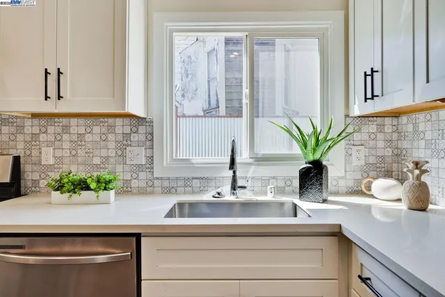 a stove top oven sitting inside of a kitchen