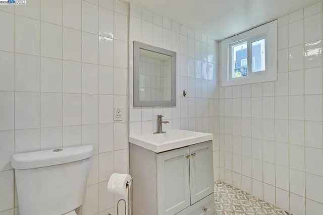 a bathroom with a toilet sink and mirror
