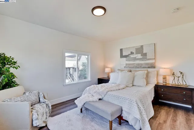 a bed sitting in a bedroom next to a window