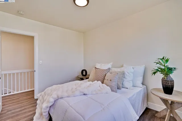 a bedroom with a bed and a potted plant