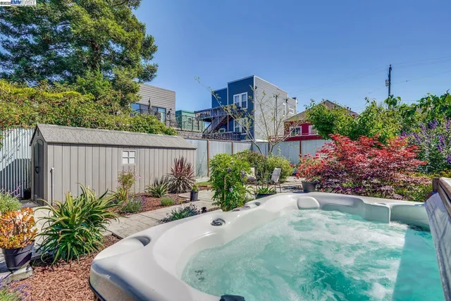 a front view of a house with a yard and potted plants