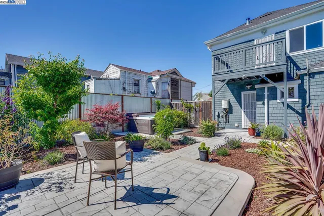 a view of a house with backyard and sitting area