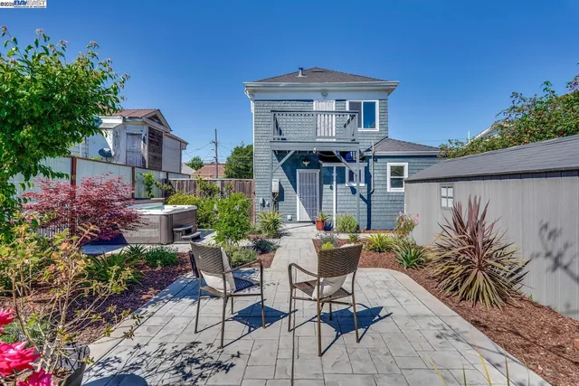 a front view of a house with a yard and fountain in middle