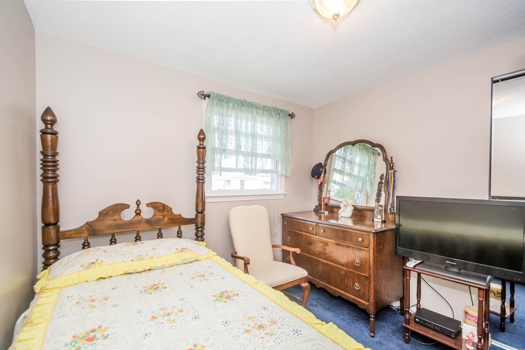 52 Westwind Road Lowell, MA 01852 - Photo 11 of 28 a bedroom with a bed and a large window