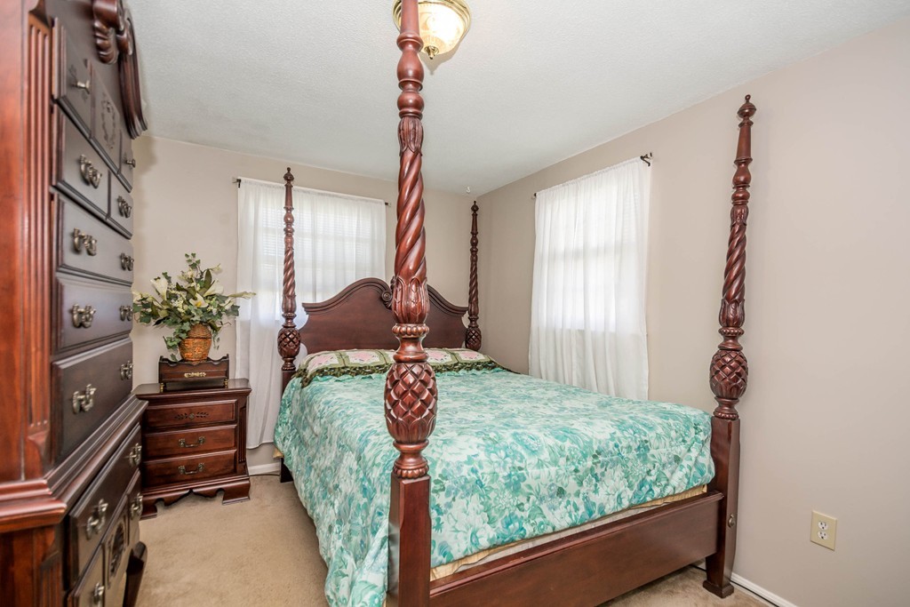 52 Westwind Road Lowell, MA 01852 - Photo 12 of 28 a bed room with a bed and a window