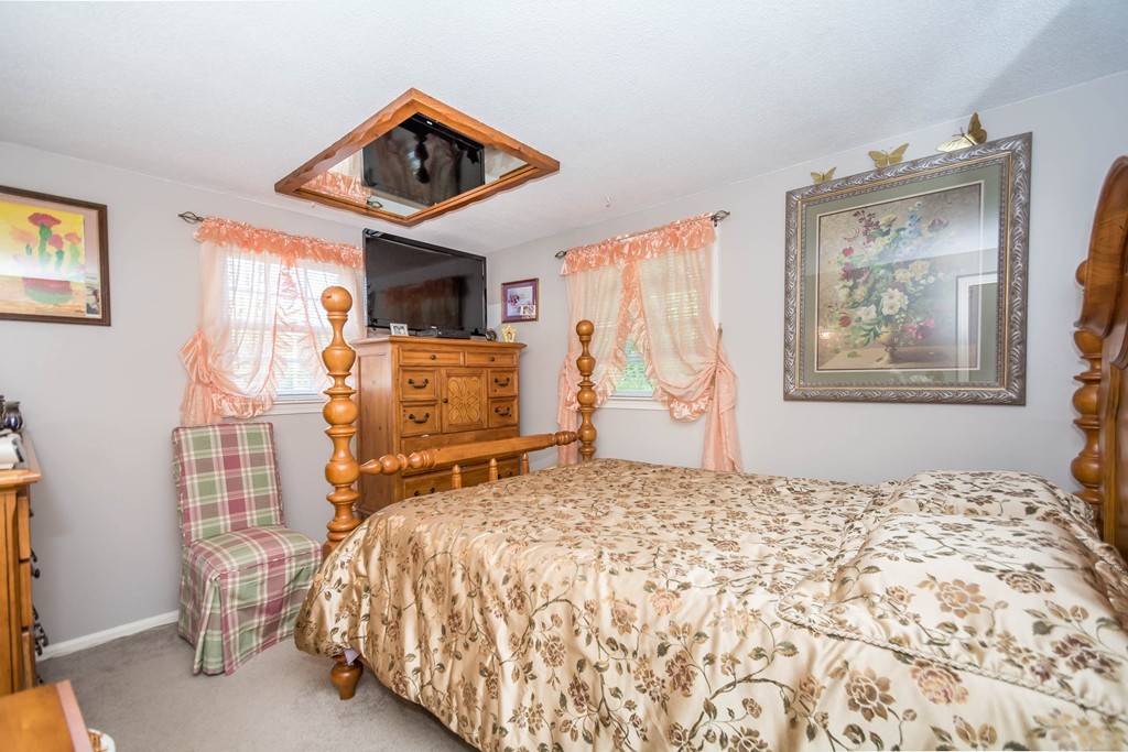 52 Westwind Road Lowell, MA 01852 - Photo 16 of 28 a bedroom with a bed and wooden floor