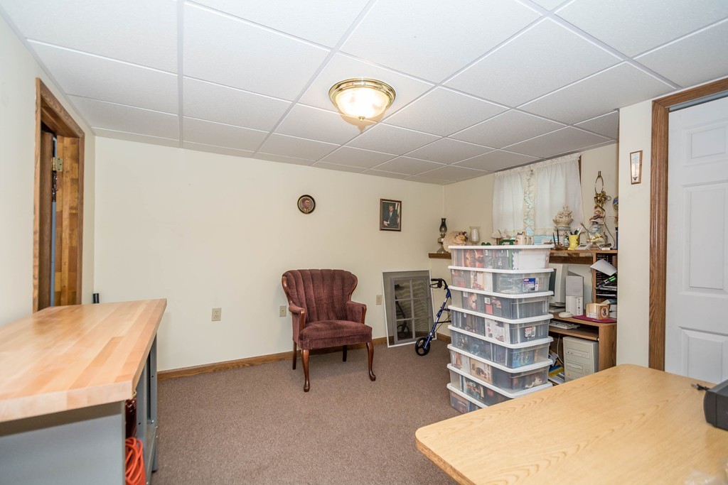 52 Westwind Road Lowell, MA 01852 - Photo 22 of 28 a room with a chair and white walls