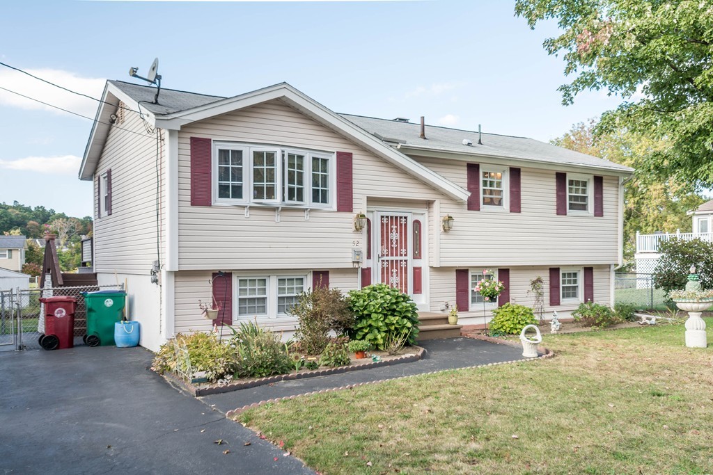 52 Westwind Road Lowell, MA 01852 - Photo 24 of 28 a front view of a house with garden