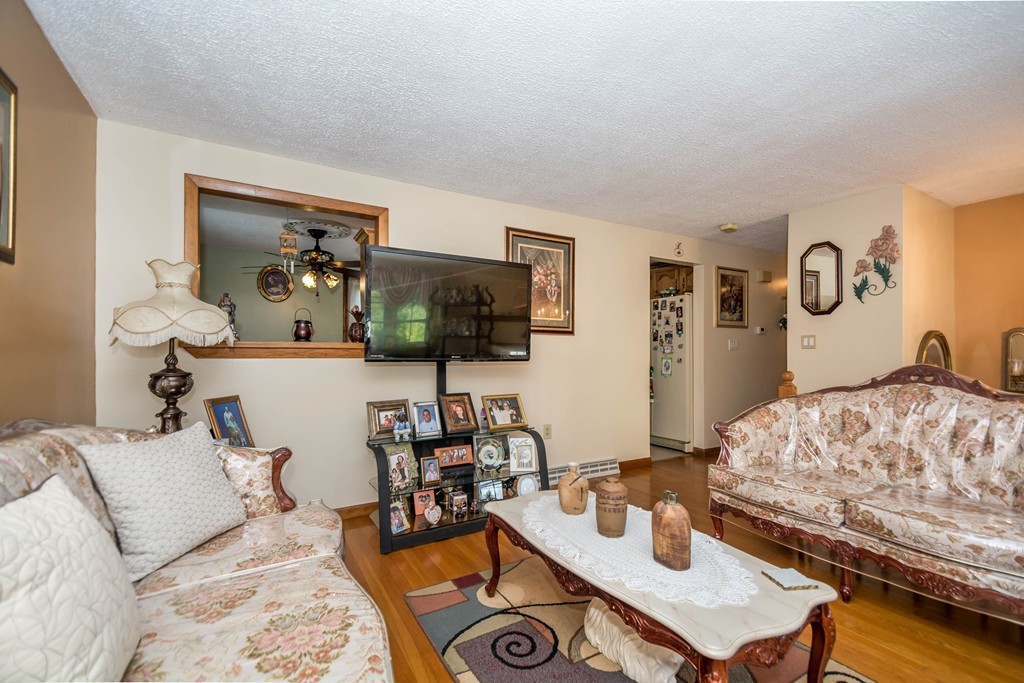 52 Westwind Road Lowell, MA 01852 - Photo 4 of 28 a living room with furniture and flat screen tv