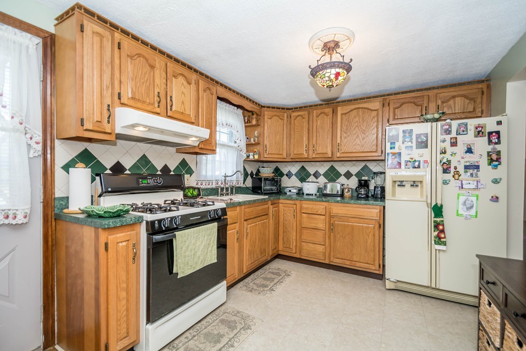 52 Westwind Road Lowell, MA 01852 - Photo 6 of 28 a kitchen with stainless steel appliances granite countertop a stove a sink dishwasher and a refrigerator