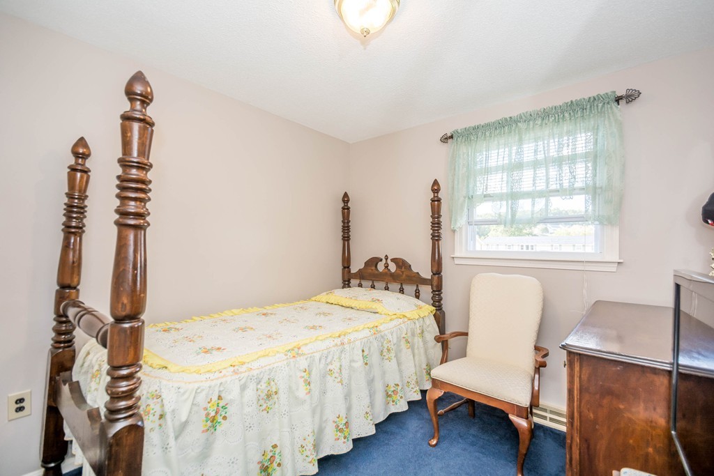 52 Westwind Road Lowell, MA 01852 - Photo 9 of 28 a bedroom with a bed and a window