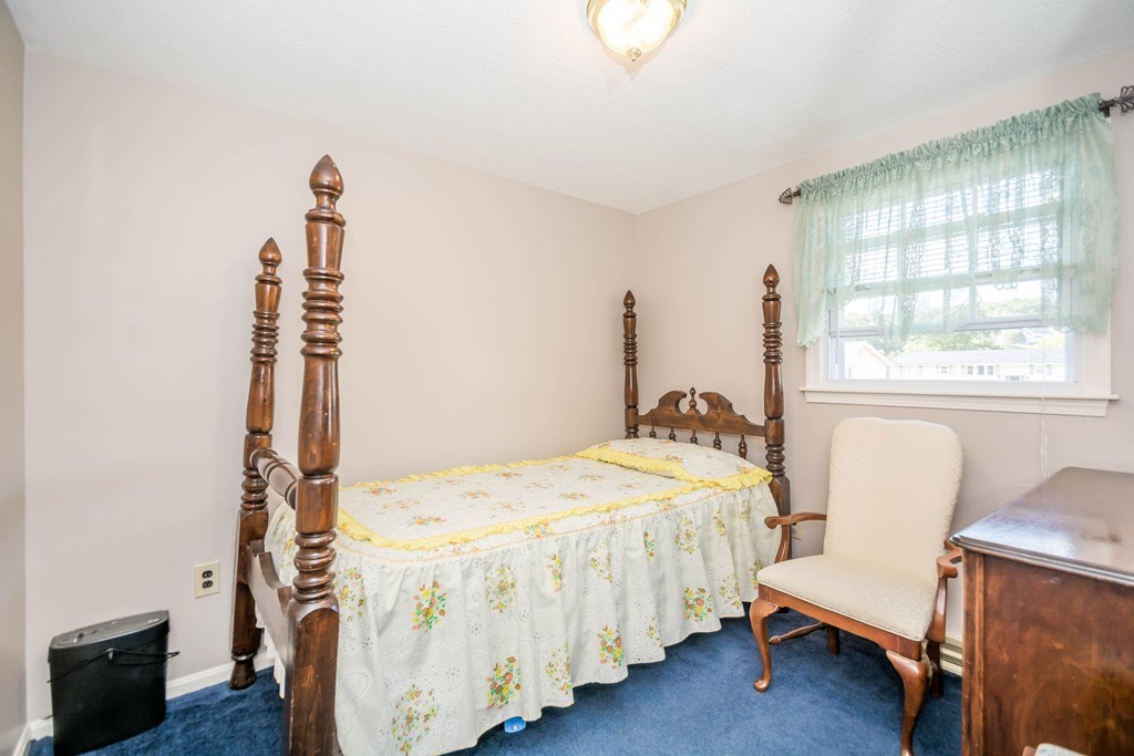 52 Westwind Road Lowell, MA 01852 - Photo 10 of 28 a bedroom with a bed and a window