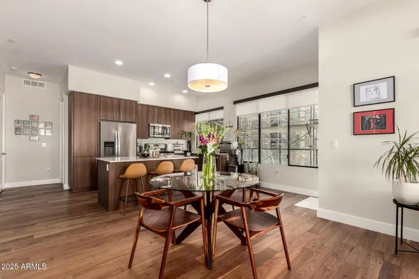 a view of a dining room with furniture window and wooden floor