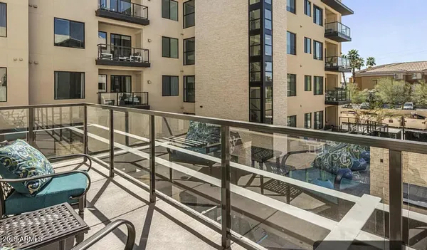 a view of a balcony with two chairs and a table