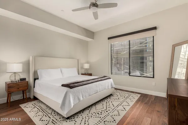 a bedroom with a large bed and a window