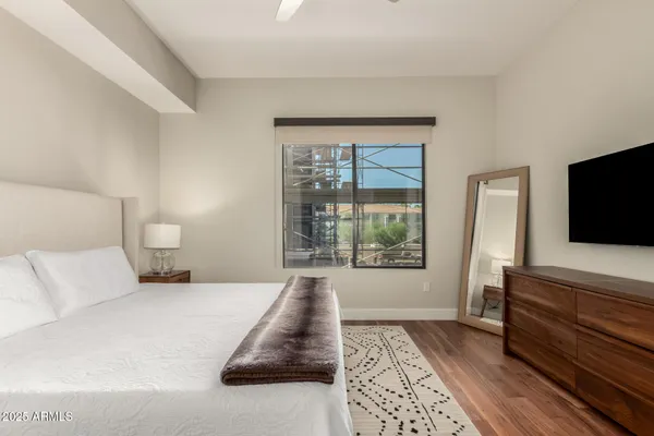 a bedroom with a bed and a flat screen television