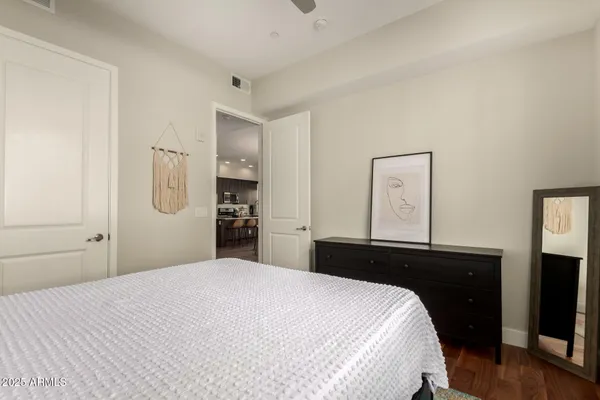 a bedroom with a bed and a dresser