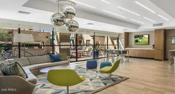 a living room with lots of furniture and a chandelier