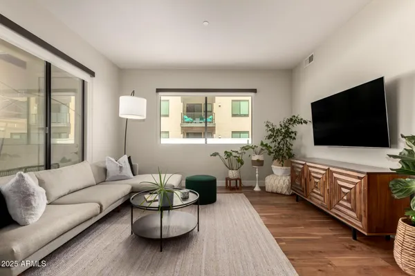 a living room with furniture and a flat screen tv