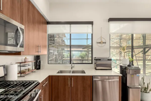 a kitchen with stainless steel appliances a sink and a stove