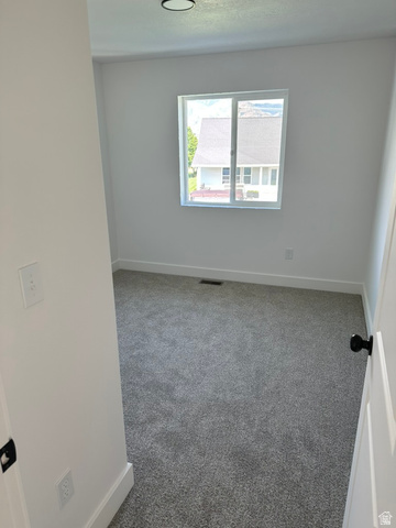 1886 North 300 West Logan, UT 84341 - Photo 14 of 18 Bedroom featuring a single window, grey carpet, and white walls