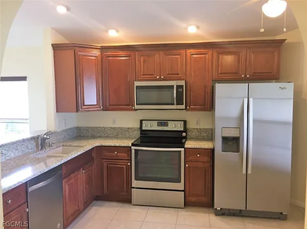 a kitchen with a sink stainless steel appliances and cabinets