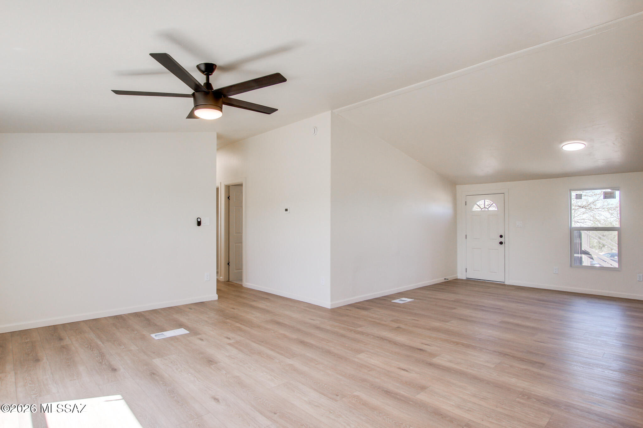 14303 West Rolina Lane Tucson, AZ 85736 - Photo 12 of 38 a view of a big room with wooden floor and windows in a room