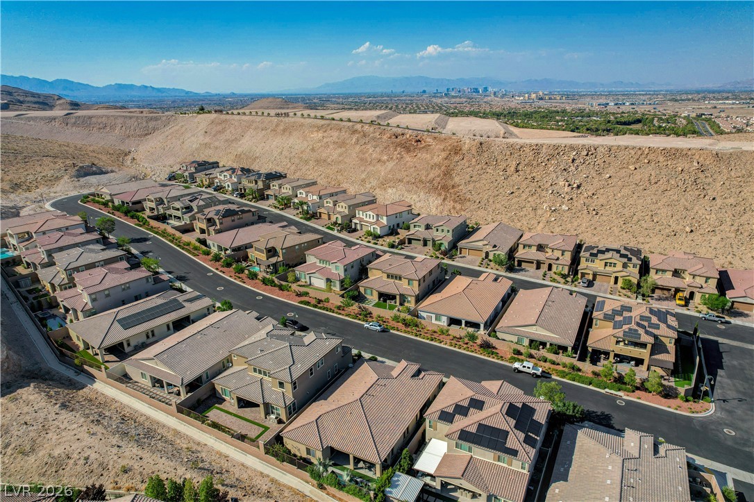 3943 Reyes Avenue Las Vegas, NV 89141 - Photo 69 of 95 An aerial perspective reveals a vibrant community nestled into the desert landscape with mountain and city views.