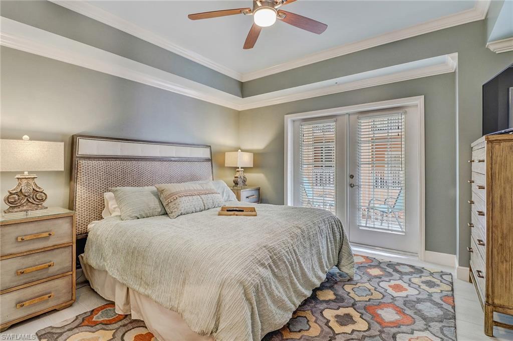 401 Bayfront Place, Unit 3208 Naples, FL 34102 - Photo 11 of 22 a bedroom with a large bed and a chandelier