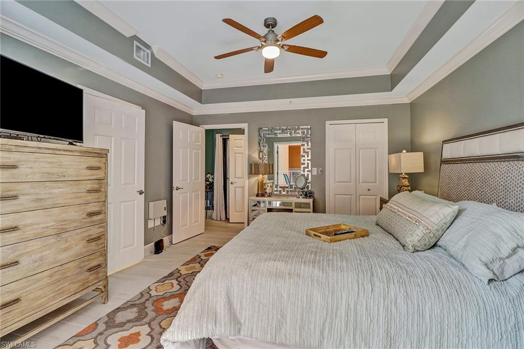 401 Bayfront Place, Unit 3208 Naples, FL 34102 - Photo 12 of 22 a bedroom with a bed and a flat screen tv