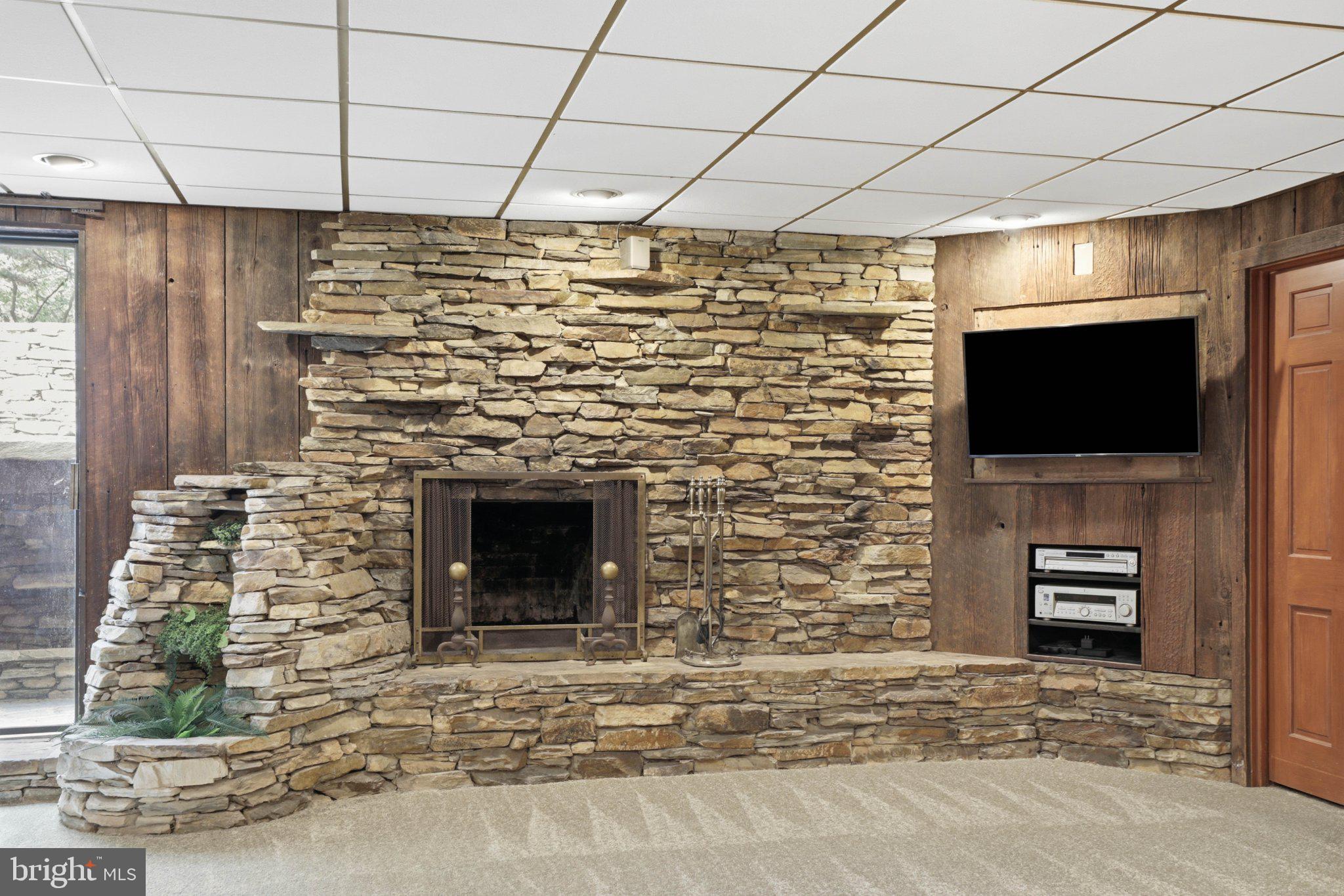 1300 Newton Road Lancaster, PA 17603 - Photo 44 of 68 Cozy stone fireplace in a warm setting.