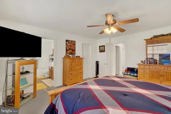 a bedroom with furniture and a flat screen tv