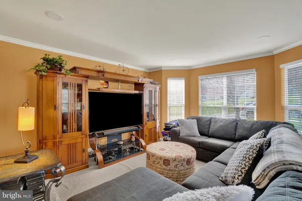 a kitchen with stainless steel appliances granite countertop a stove top oven a sink dishwasher a refrigerator and cabinets with wooden floor