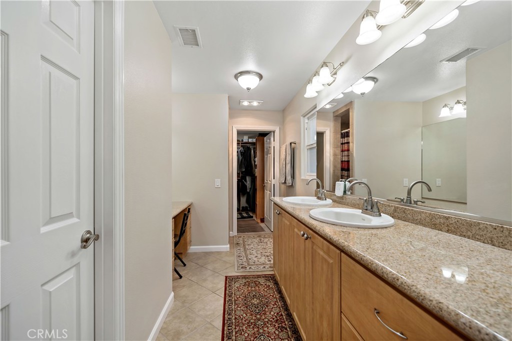 47333 Pala Road Temecula, CA 92592 - Photo 21 of 29 a spacious bathroom with a granite countertop sink a mirror and a shower
