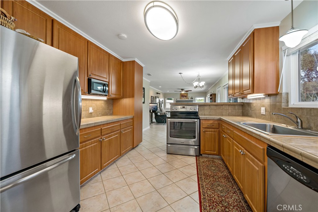 47333 Pala Road Temecula, CA 92592 - Photo 26 of 29 a kitchen with granite countertop a refrigerator stove and sink