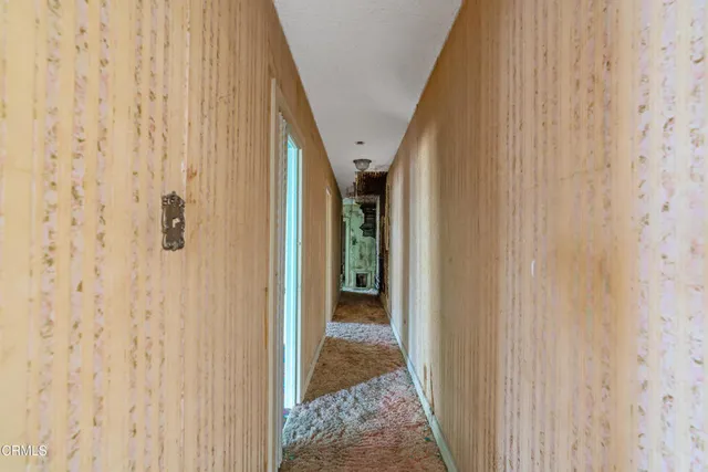 a view of a hallway with wooden floor and entryway