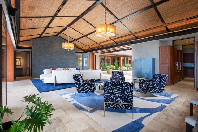 a living room with furniture and flowers