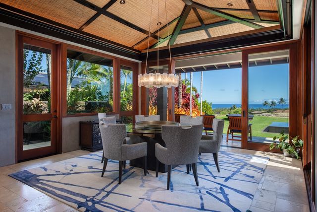 a view of a dining table and chairs in porch